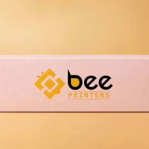 Custom macaron boxes in soft pastel pink, long and slim with the Bee Printers logo printed on the closed lid