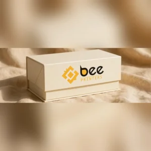 closed custom partial cover rigid boxes wholesale in cream finish with Bee Printers logo on the cover, studio photo on warm linen backdrop