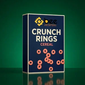 Navy blue Crunch Rings cardboard cereal box with the Bee Printers logo at the top and pink ring cereal graphics scattered across the front on a dark green background, showing cereal cardboard boxes