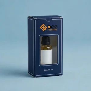 Closed navy blue box with a white frame and rectangular window showing a beard oil bottle with a white label and black cap on a light blue background with the Bee Printers logo, showing custom beard oil boxes with window