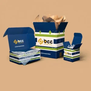 Three open navy blue mailer boxes with white and green striped pattern filled with bubble wrap, brown tissue paper and white packing material on a solid tan background with the Bee Printers logo on the front and inside lid, showing custom boxes juneau alaska