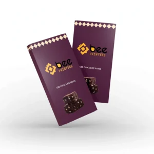 Two tall closed purple boxes with cream diamond trim at the top and a stacked chocolate brownie image on the front float against a white background, showing custom cbd chocolate boxes.
