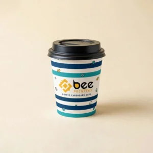 A single cardboard coffee cup with blue and teal horizontal stripes and small coffee bean icons and a black lid with the Bee Printers logo centred on the front on a plain cream background, showing custom coffee cardboard cups.