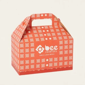 Closed orange-red gable box with a white checkerboard and dot pattern on a cream background, showing custom gable lunch boxes.