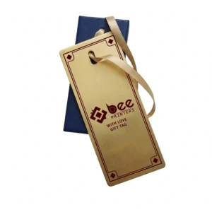 A brushed gold custom hanging gift tags with a burgundy border, Bee Printers logo and WITH LOVE GIFT TAG text, tied with a champagne ribbon over a navy tag on a white background.