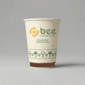A single cream mushroom coffee cup without a lid with a green mushroom and coffee bean band near the base and a brown base band with the Bee Printers logo centred on the front on a light grey background, showing custom mushroom coffee cups.