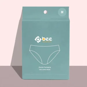 Closed teal custom panties packaging box with a hanging hole, size M mark and a white line drawing of briefs, standing against a pale pink background.