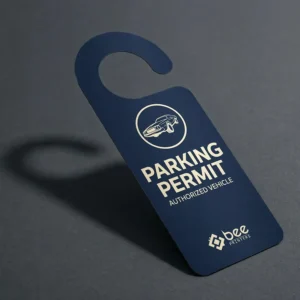 A single dark navy hook-shaped custom parking hang tags tag reading Parking Permit Authorized Vehicle with a car icon and white Bee Printers logo on a dark grey background.