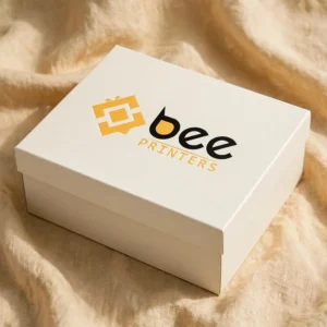Custom rigid shoe boxes in cream with the Bee Printers logo printed on the closed lid