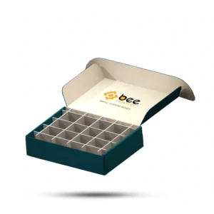 An open dark teal small box with an empty white grid divider insert inside and the Bee Printers logo and Small Custom Boxes text inside its cream lid on a white background, showing custom small custom boxes